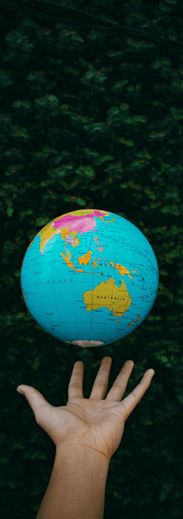 Core Values - Hand reaching for globe representing global financial inclusion