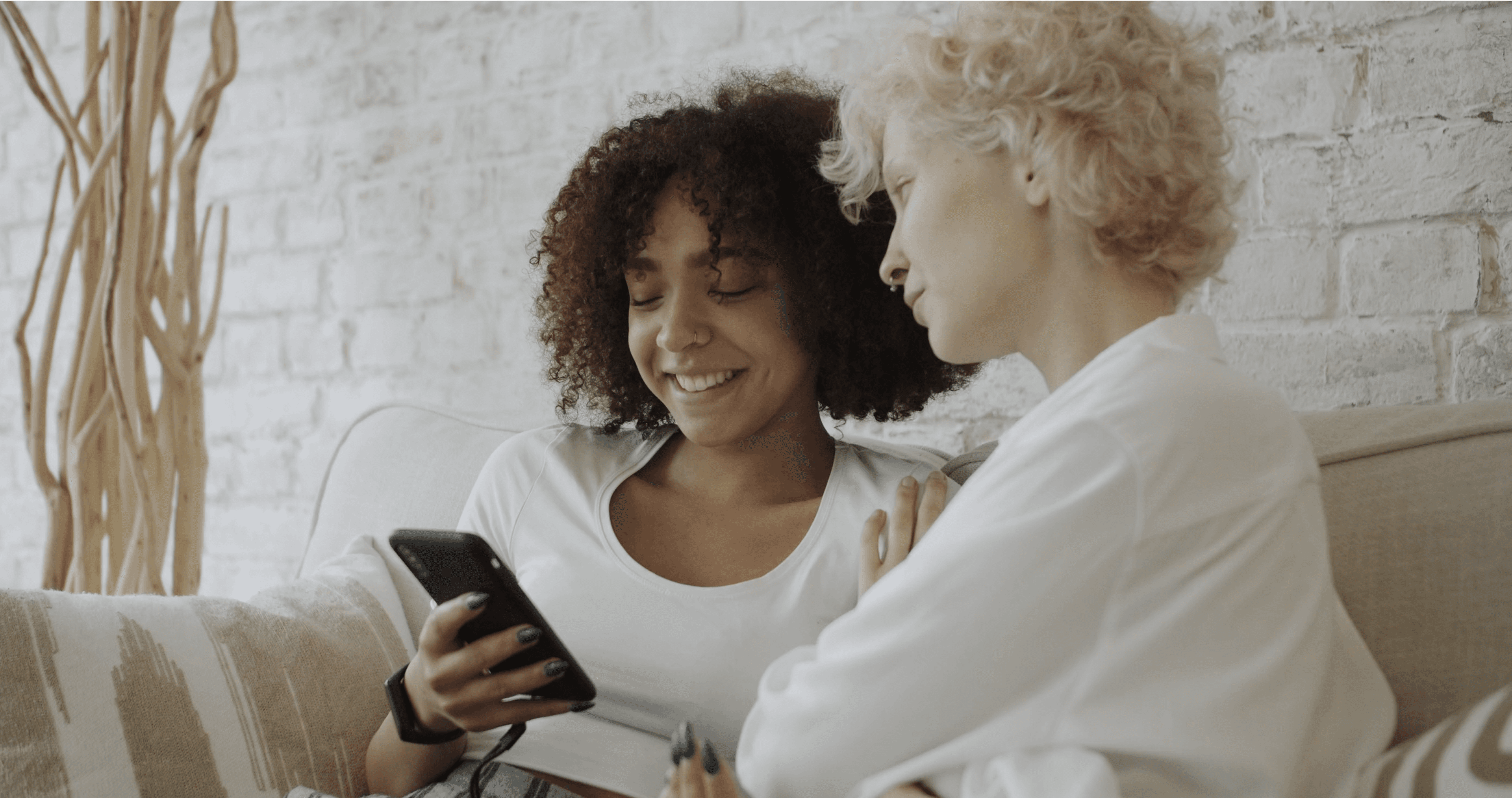 Two women looking at a smartphone