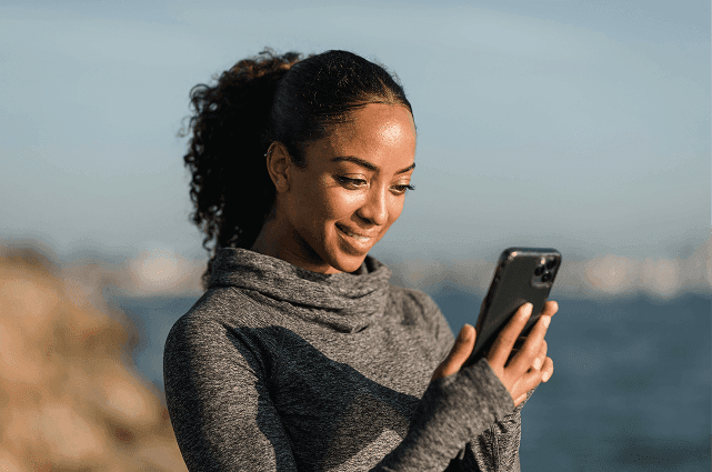 Woman looking at phone with excitement