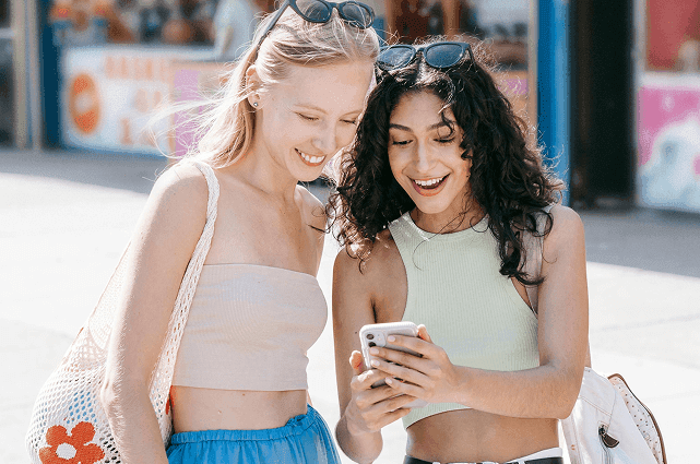 Woman looking at phone with excitement