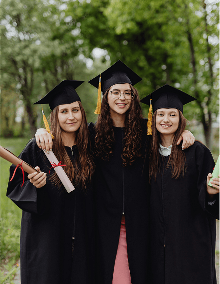 Three graduates in caps and gowns