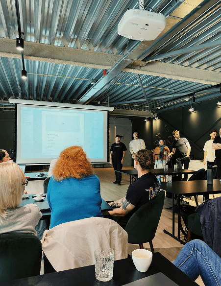 People attending a presentation in an office